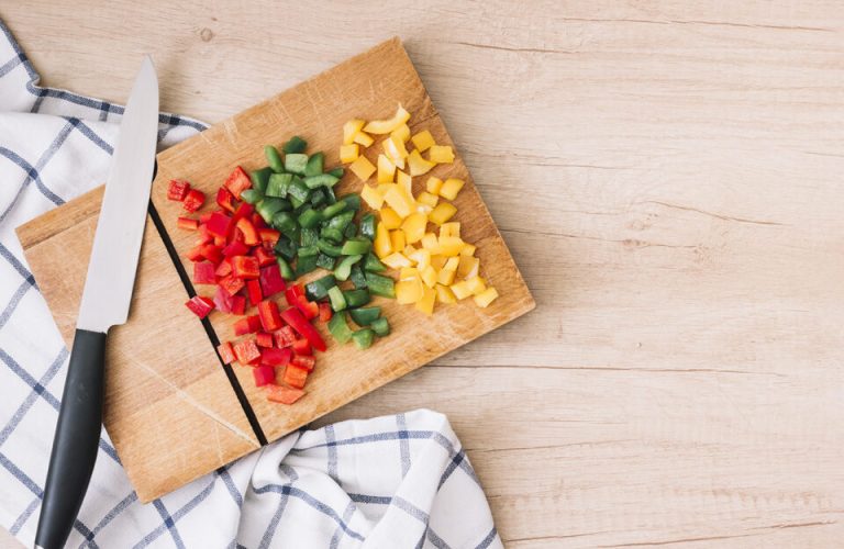 fresh-organic-chopped-red-yellow-green-bell-peppers-chopping-board-with-knife-wooden-desk-rid